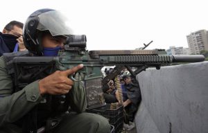 I know it's not the hot topic right now but I find it VERY odd that this Venezuelan troop is using a suppressed AR57. This rifle is set up to feed rounds from a top mounted P90 magazine, and drops the casings into the gutted magazine at the bottom. : conspiracy